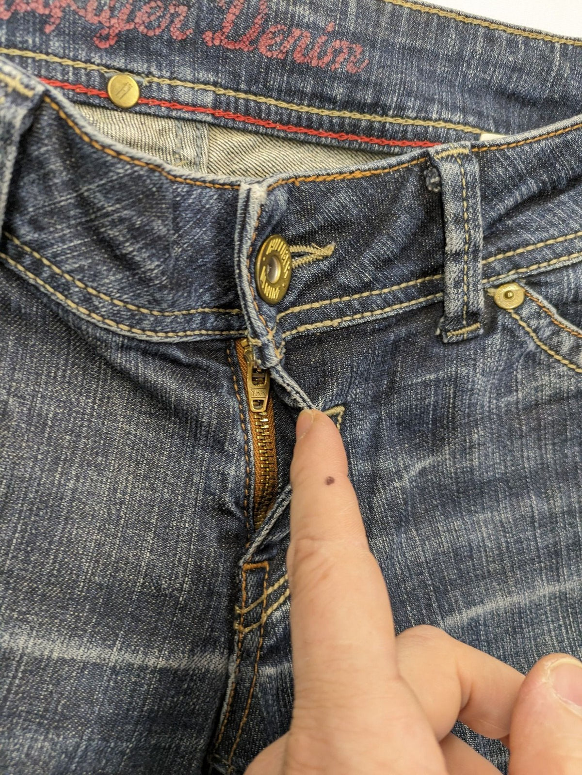 Tommy Hilfiger Denim blue straight jeans with low rise and slight used effects.