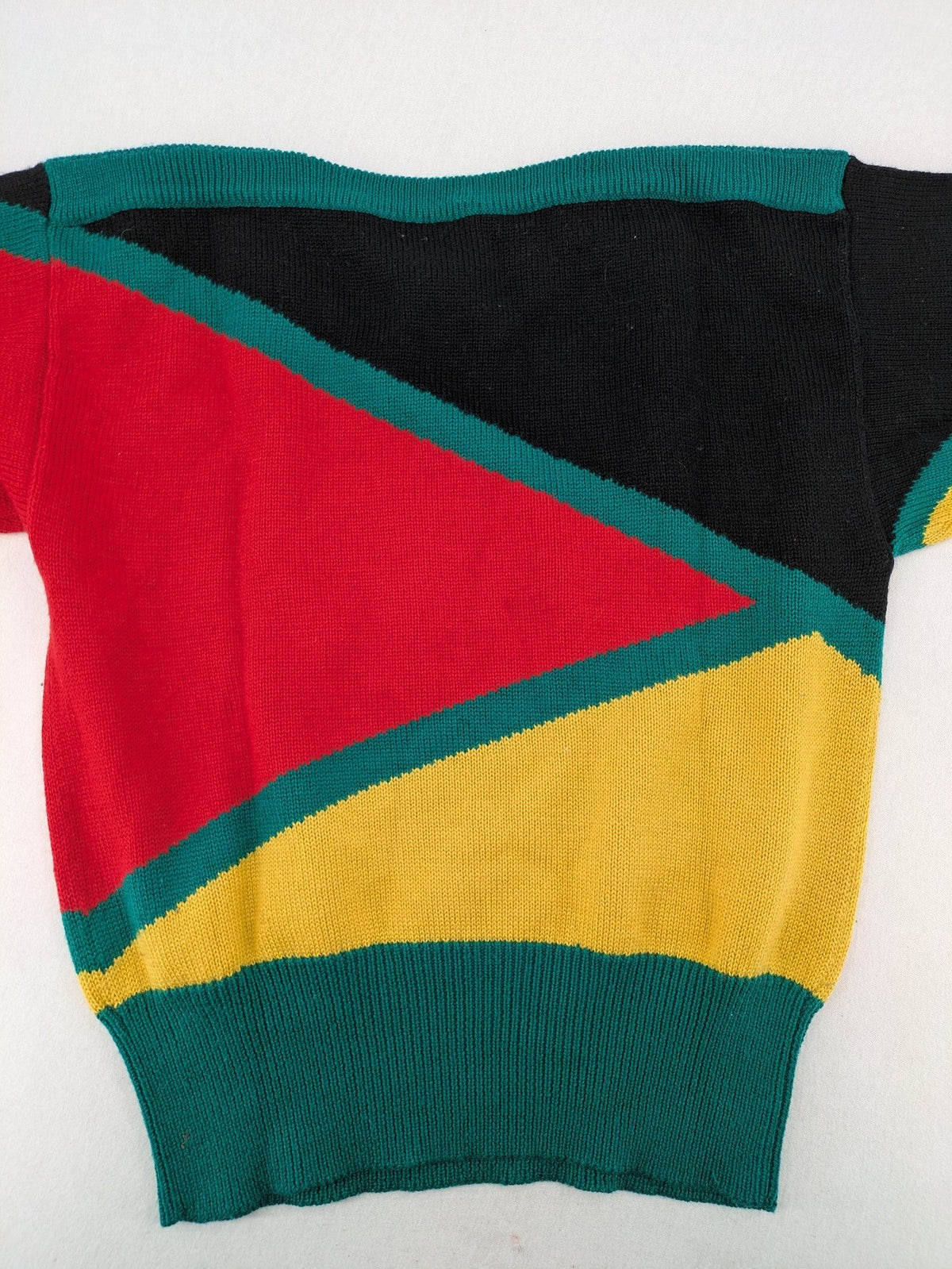 Pullover multi knit jumper featuring colorful block pattern and embroidered rooster and flowers.
