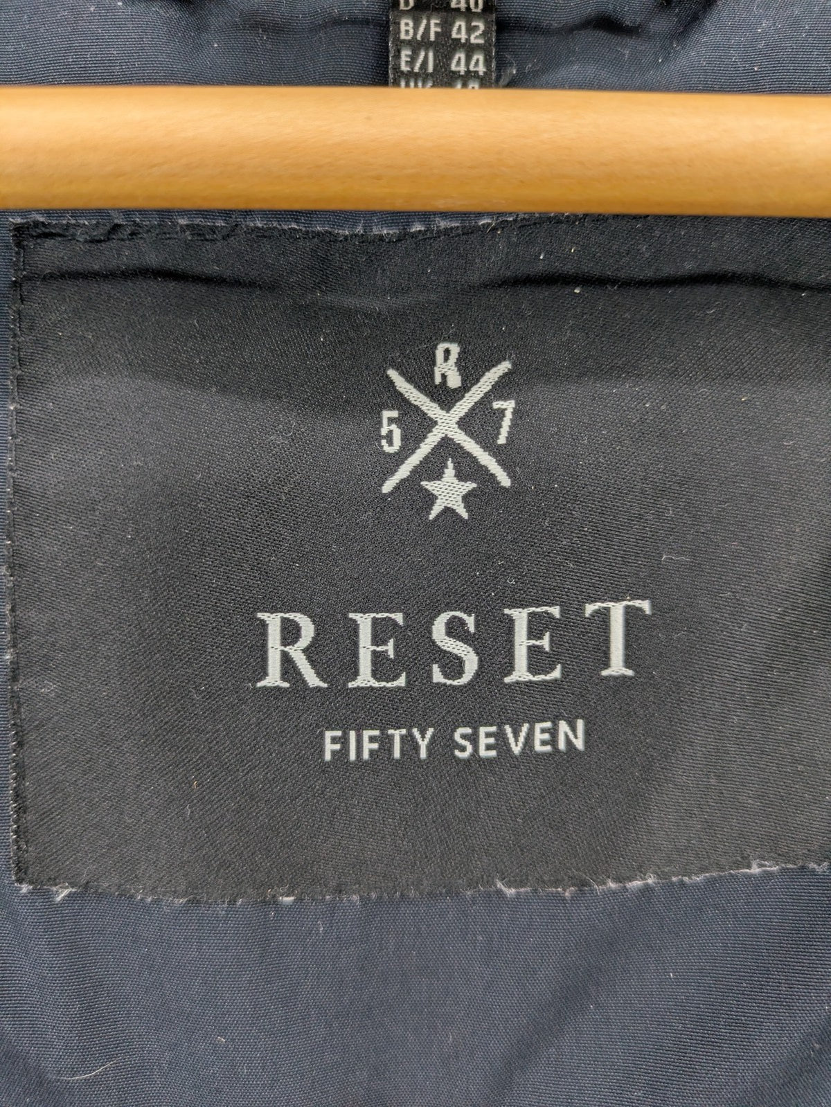 Reset Fifty Seven cream puffer coat with faux fur hood and down insulation.