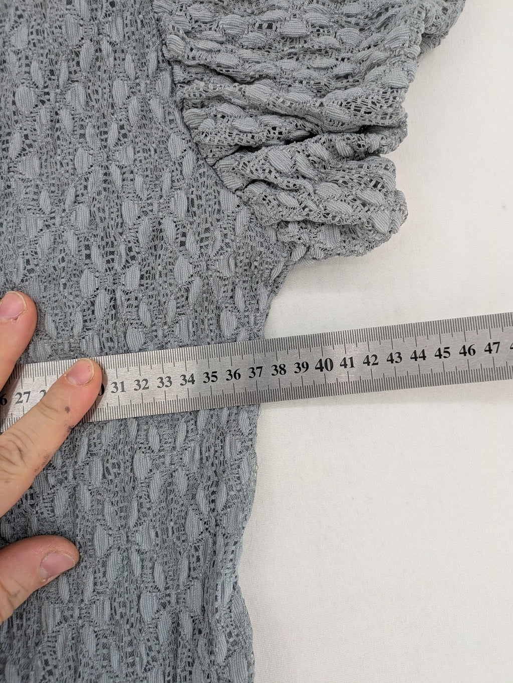 Zara grey mini dress with V-neck, puff sleeves, and textured fabric pattern.