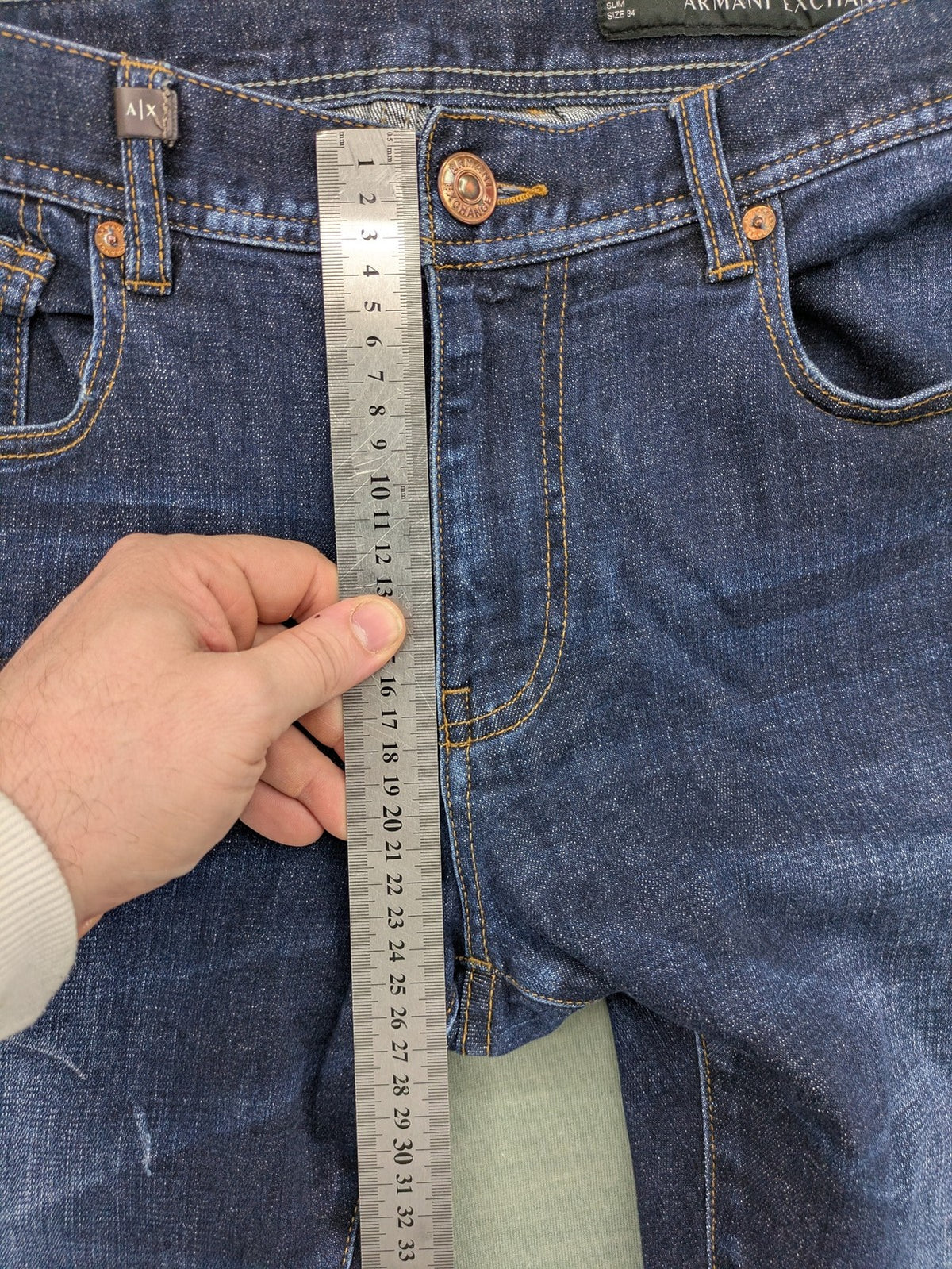 Armani Exchange blue slim fit jeans with distressed details and classic 5-pocket design.