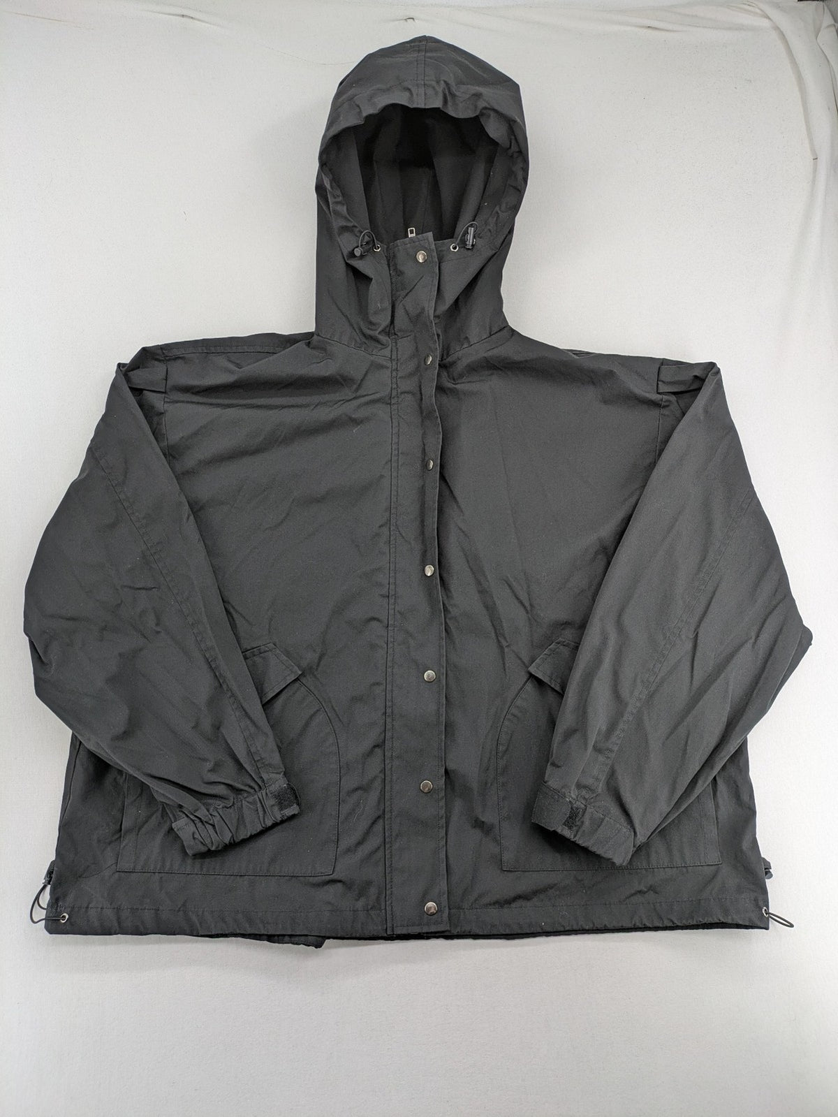 Hypnotism grey windbreaker jacket with hood, snap buttons, and zip closure.