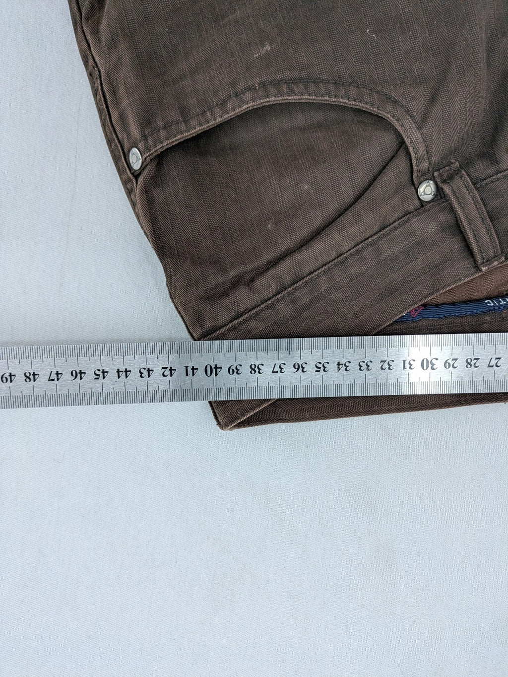 Authentic Clothing Company brown straight jeans with subtle stripe pattern and brand patch.