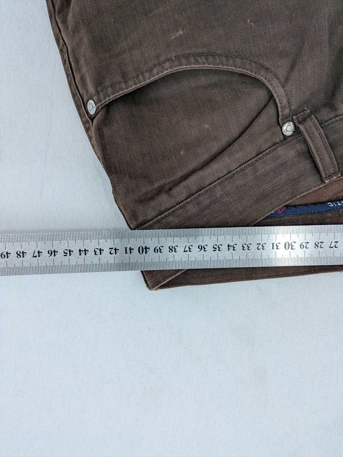 Authentic Clothing Company brown straight jeans with subtle stripe pattern and brand patch.