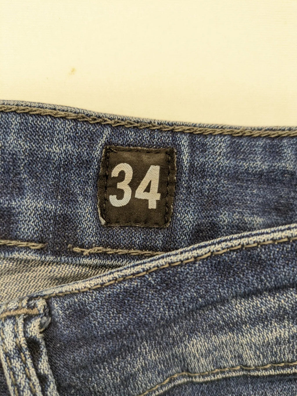 WAM Denim blue straight jeans with distressed details and button fly.
