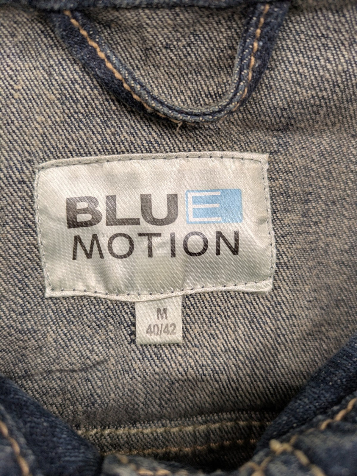 BLU blue denim trucker jacket with button placket and two chest pockets.