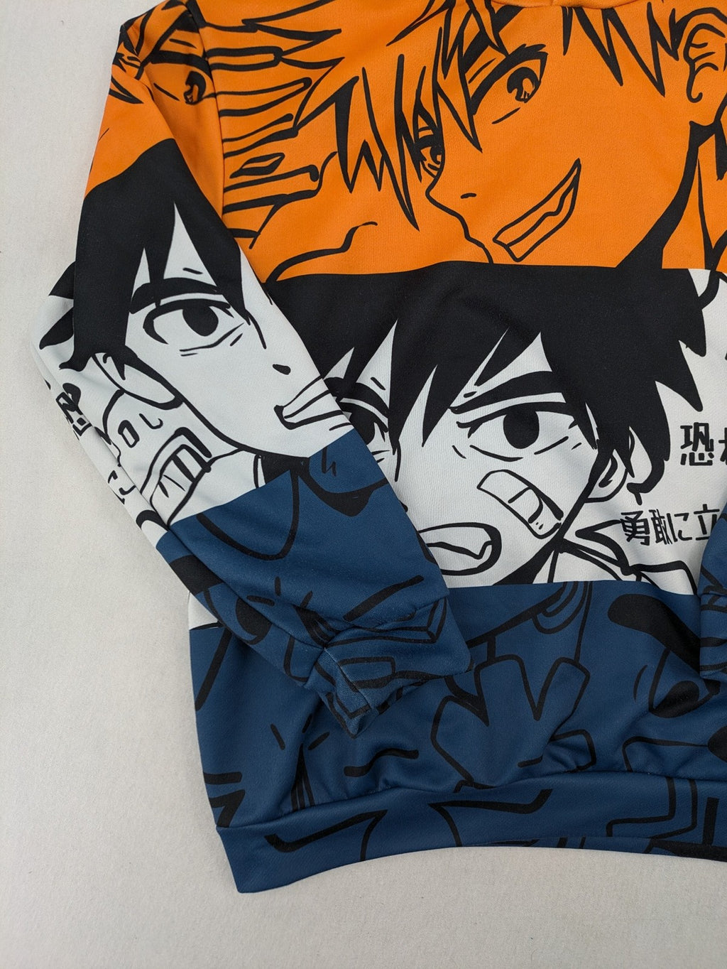 SHEIN orange zip-through hoodie with vibrant anime graphic print and colorblock design.