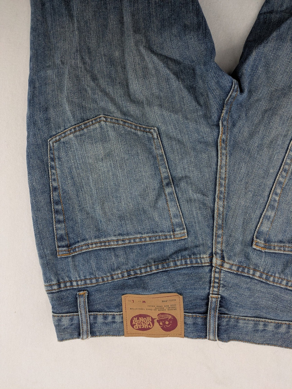 Cheap Monday blue straight jeans with button fly and classic medium wash finish.