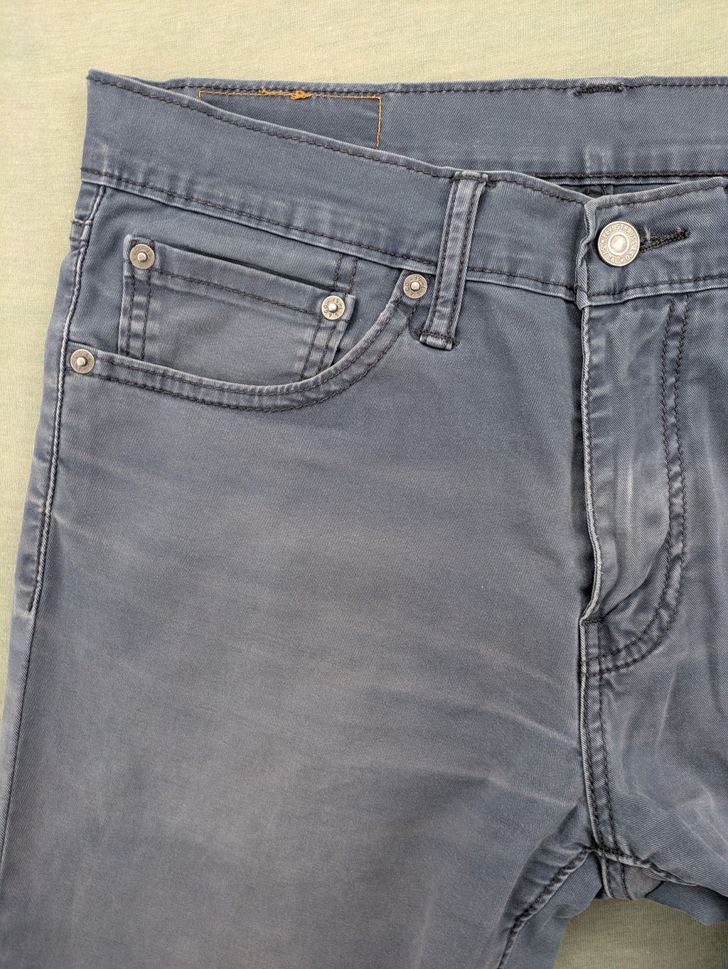 Levi's blue slim fit jeans with faded wash and classic 5-pocket design.