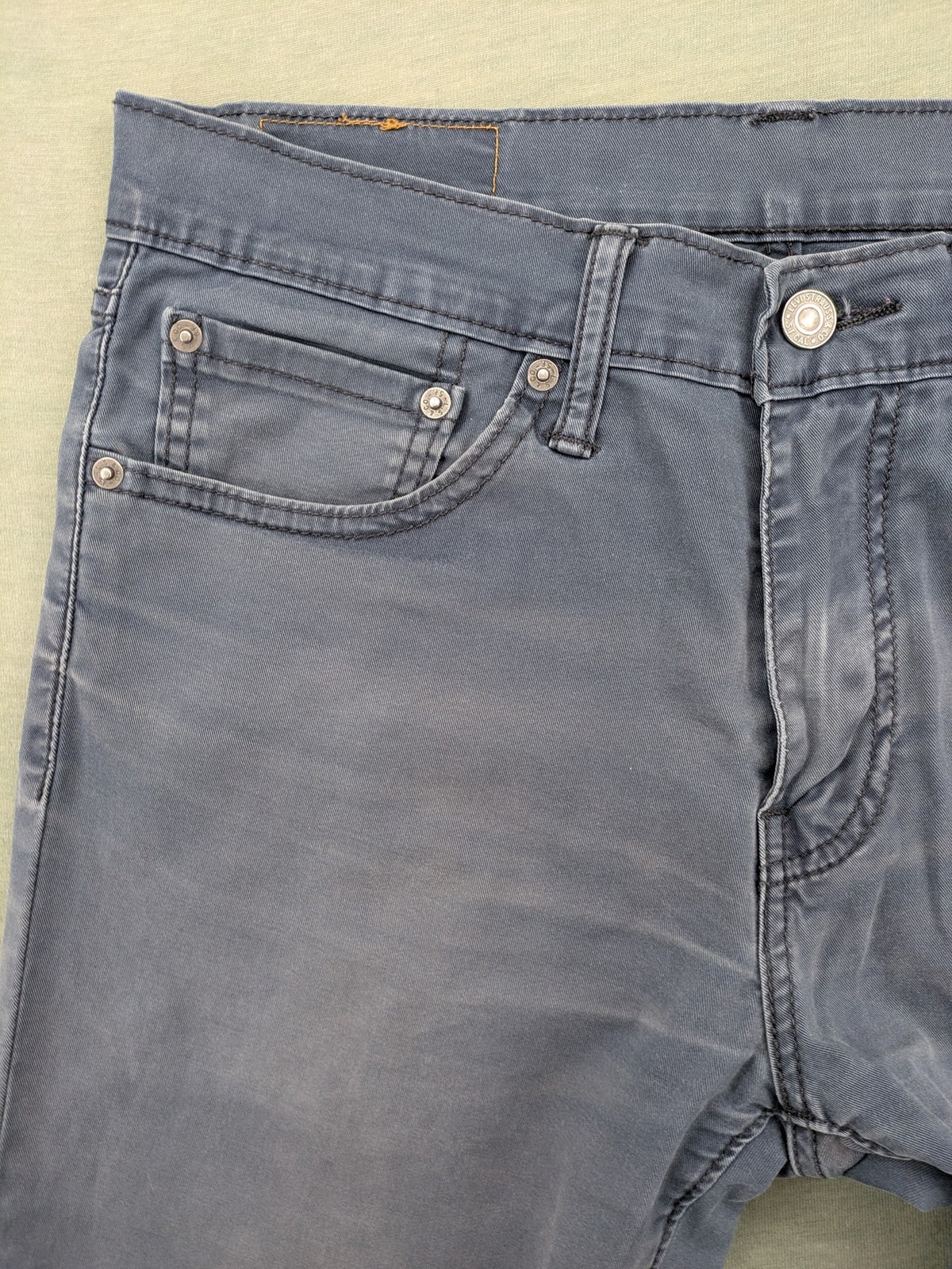 Levi's blue slim fit jeans with faded wash and classic 5-pocket design.