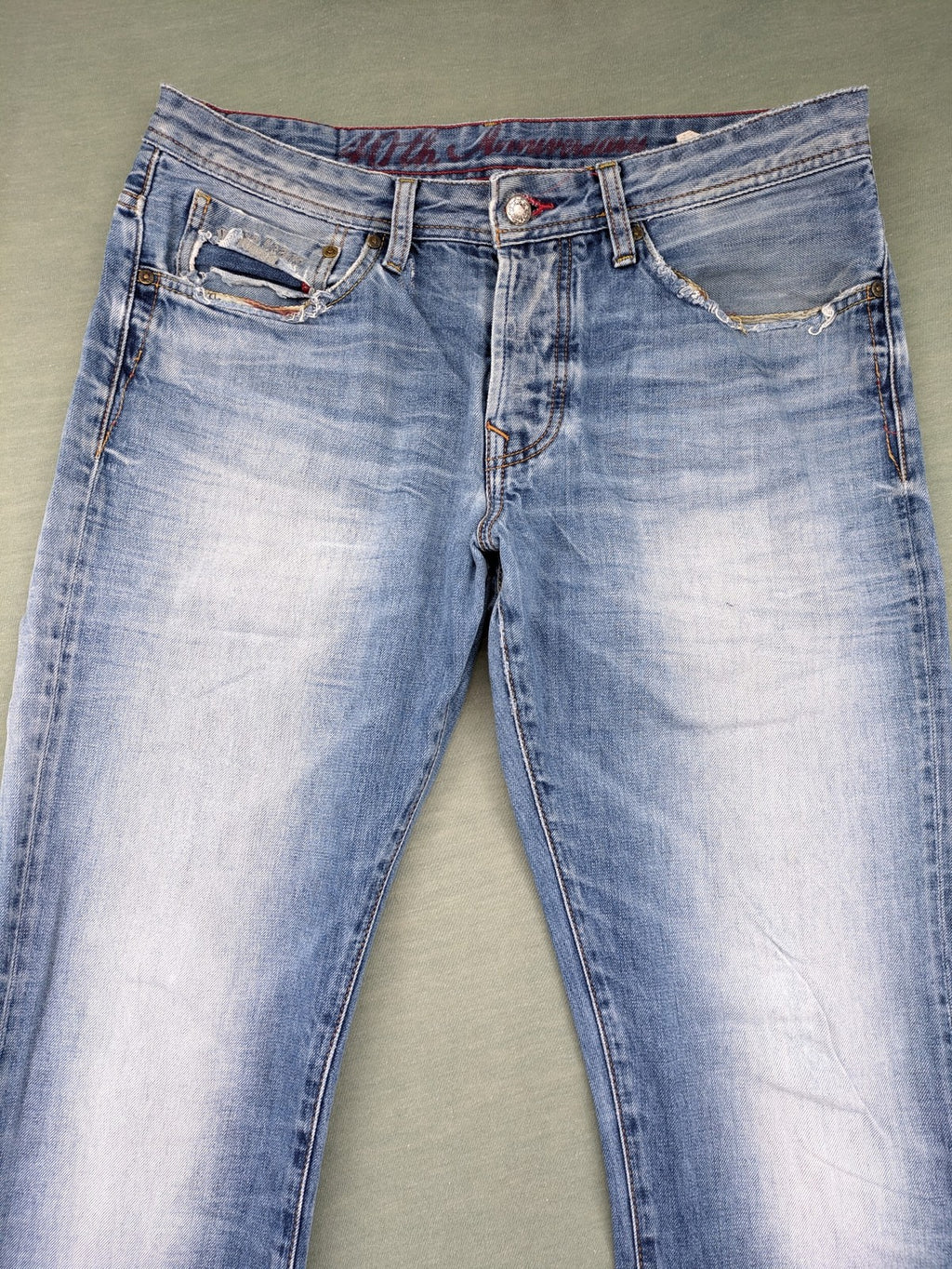 Pepe Jeans blue straight jeans with Union Jack embroidery and distressed denim finish.