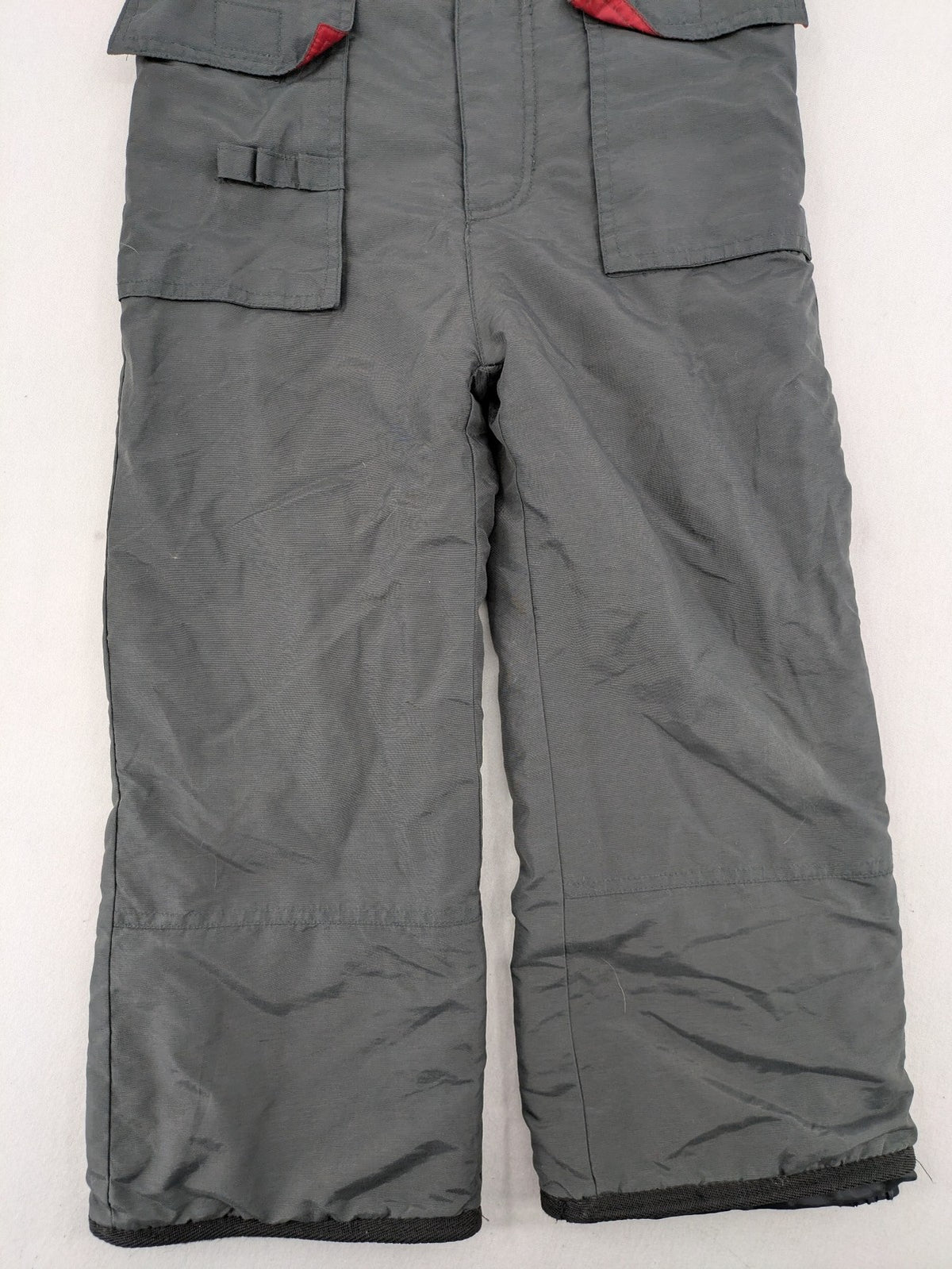 H&M grey snow pants with red accents, adjustable straps, and multiple cargo pockets.