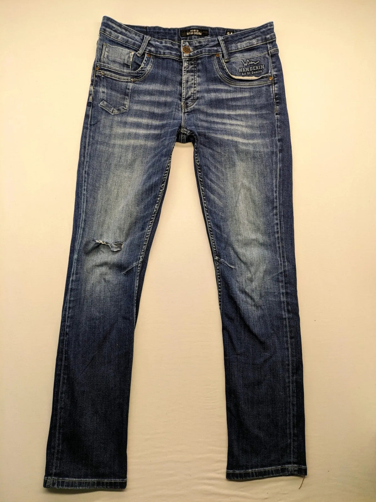 WAM Denim blue straight jeans with distressed details and button fly.