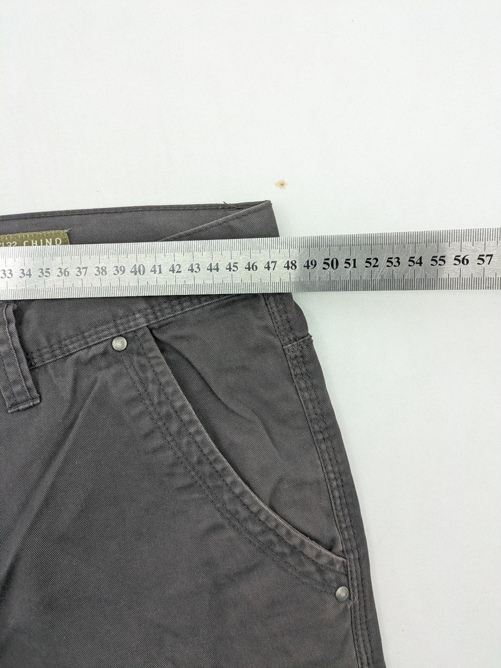 Denim & Co. grey chino pants cotton workwear with button fly and pocket rivets.