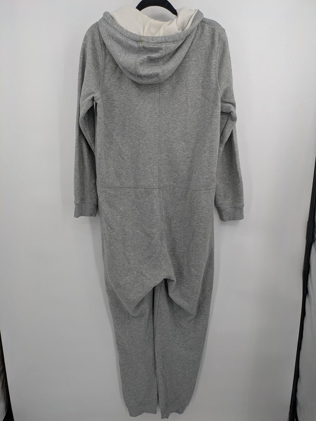 ESMARA cream jumpsuit with hood, graphic print, and front zipper, soft material.