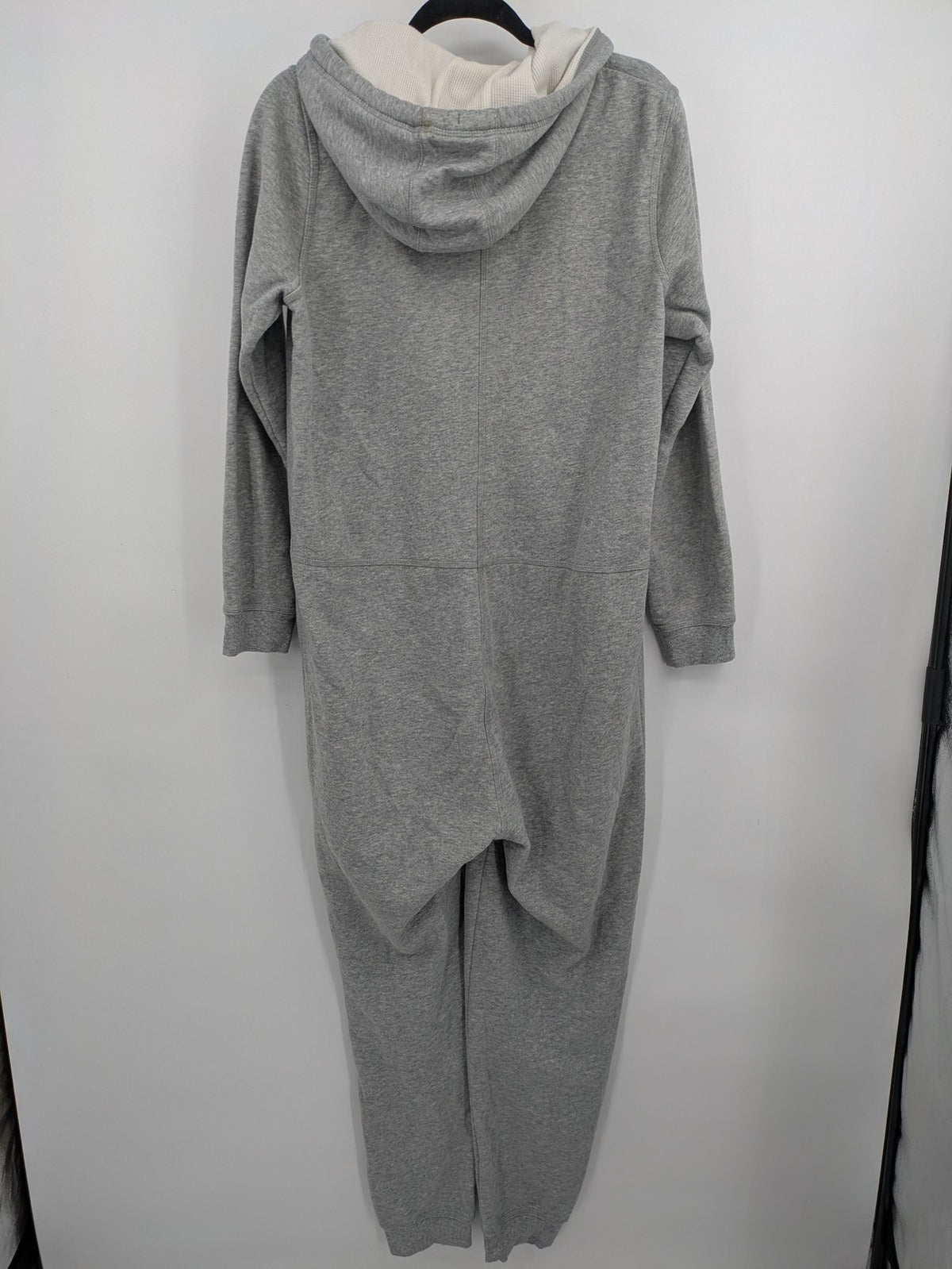 ESMARA cream jumpsuit with hood, graphic print, and front zipper, soft material.