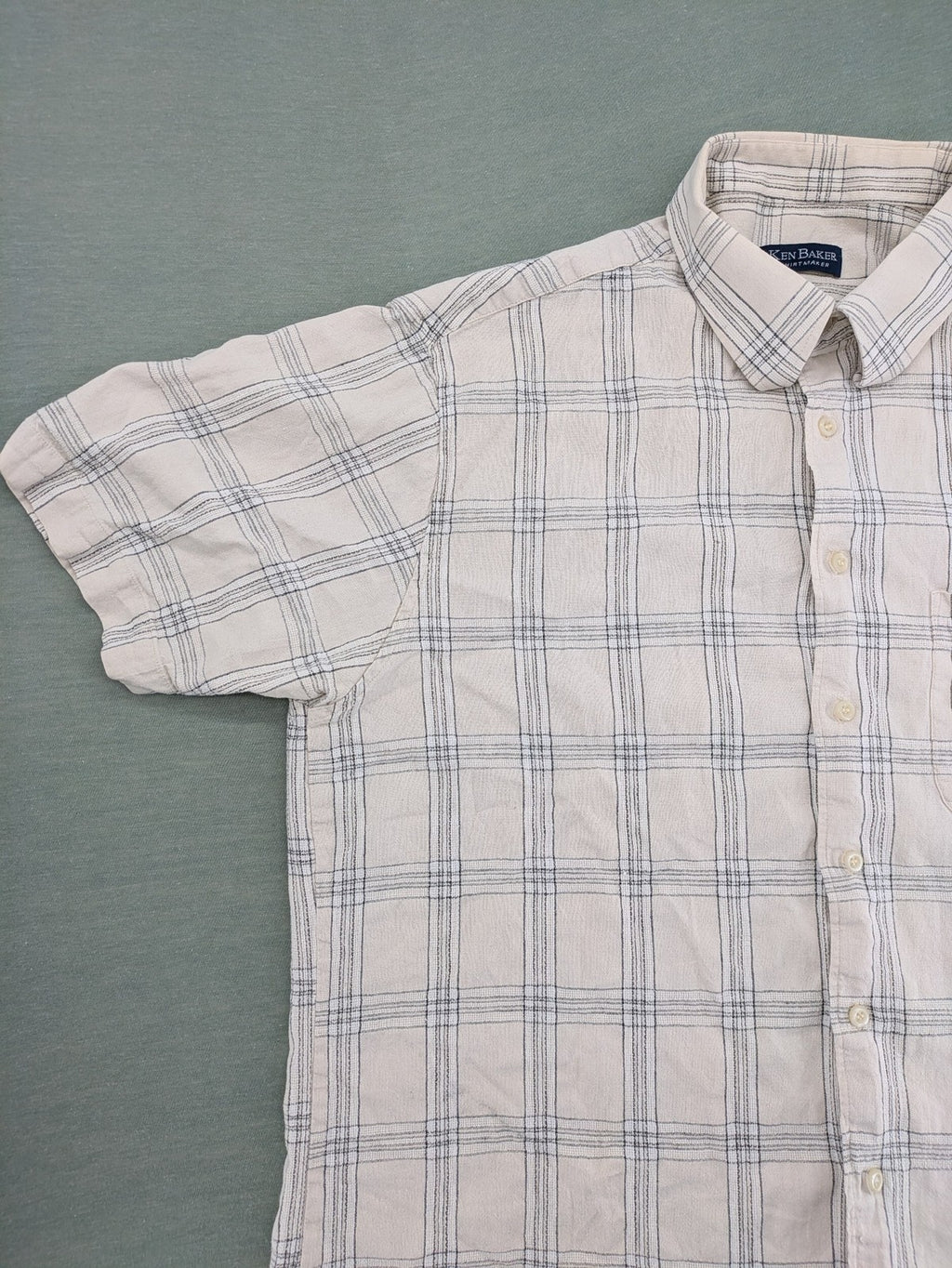 Ken Baker short-sleeve button-down shirt beige blue check pattern with single chest pocket.