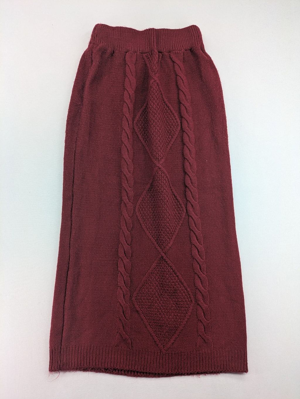 Pullover burgundy turtle neck jumper with diamond and cable knit patterns, elastic waistband.