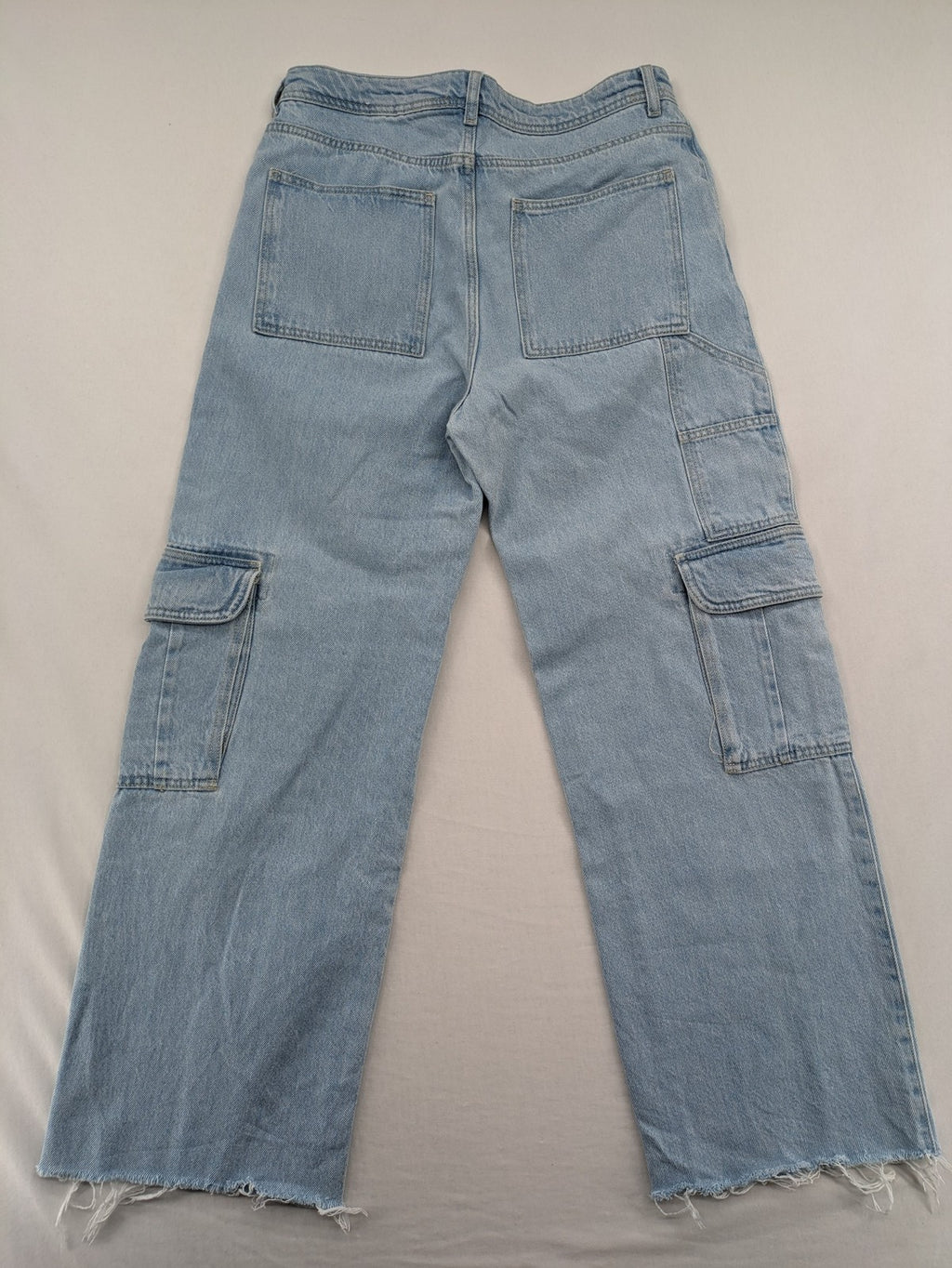 MNG blue straight jeans with cargo pockets and raw hem, high waist denim.