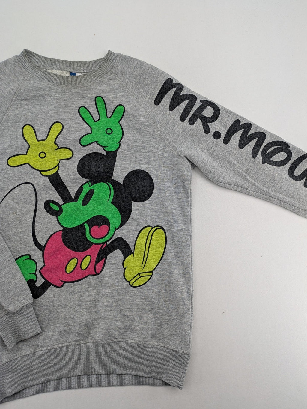 Disney turtle neck jumper multi with colorful Mickey Mouse graphic and "MR. MOUSE" sleeve text.