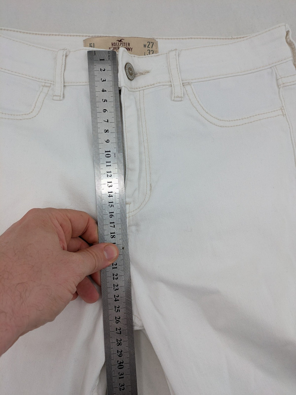 Hollister white super skinny high rise jeans with classic 5-pocket design and zipper closure.