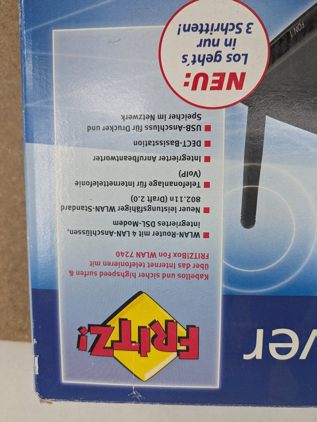 AVM black wireless router with integrated DSL modem and 1&1 logo.
