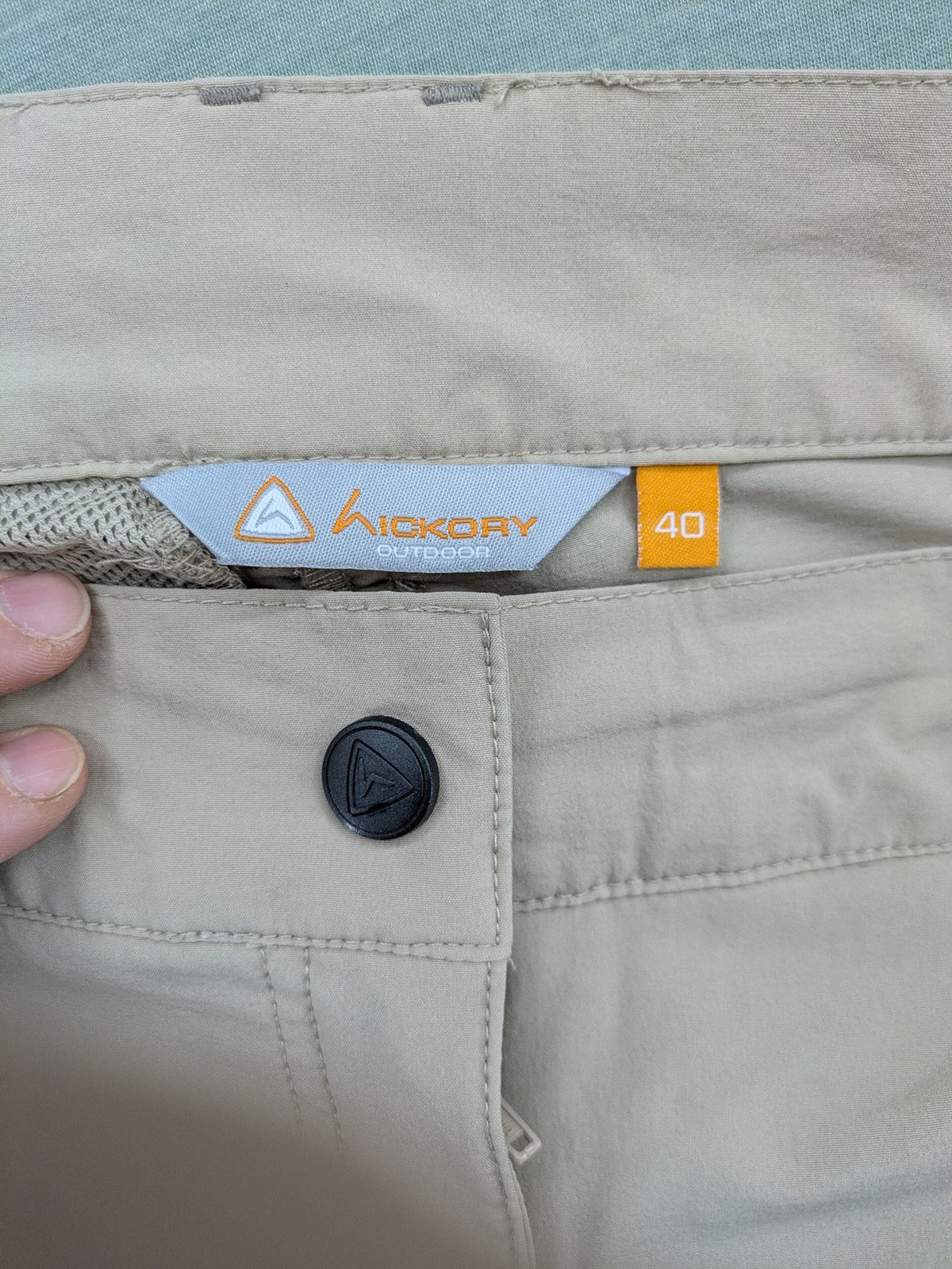 Hickory beige outdoor pants with multiple zippered pockets and stretch fabric for comfort.