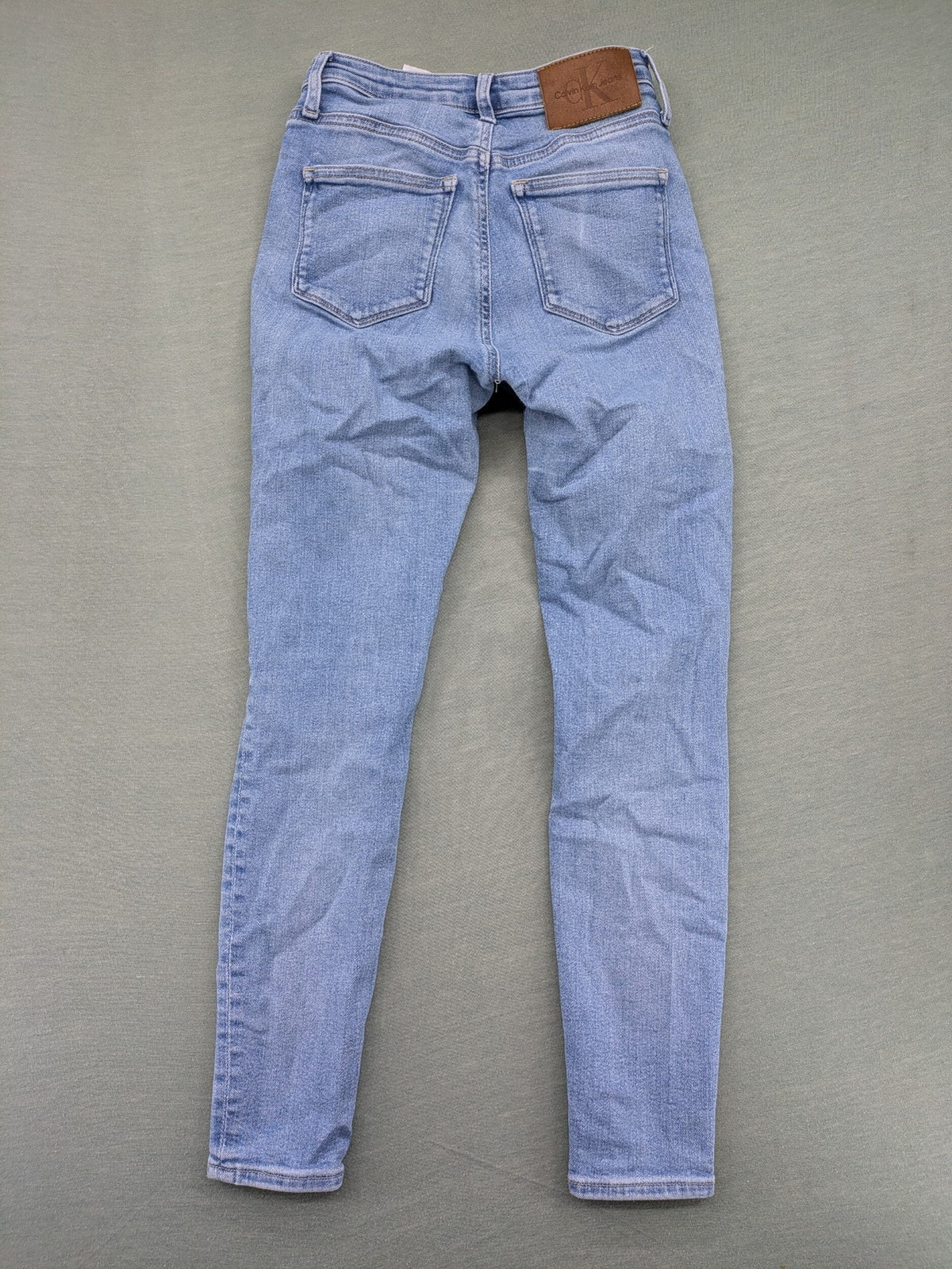 Calvin Klein Jeans blue high rise super skinny ankle jeans with logo patch and stretch material.