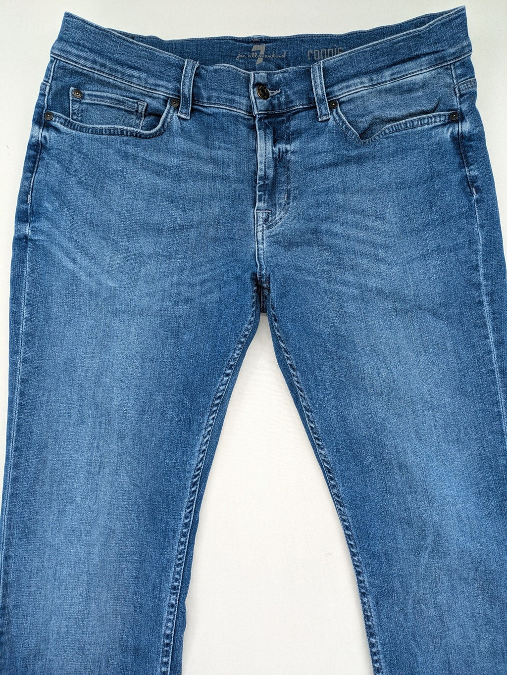 7 For All Mankind blue straight jeans with 5-pocket design and logo on back pocket.