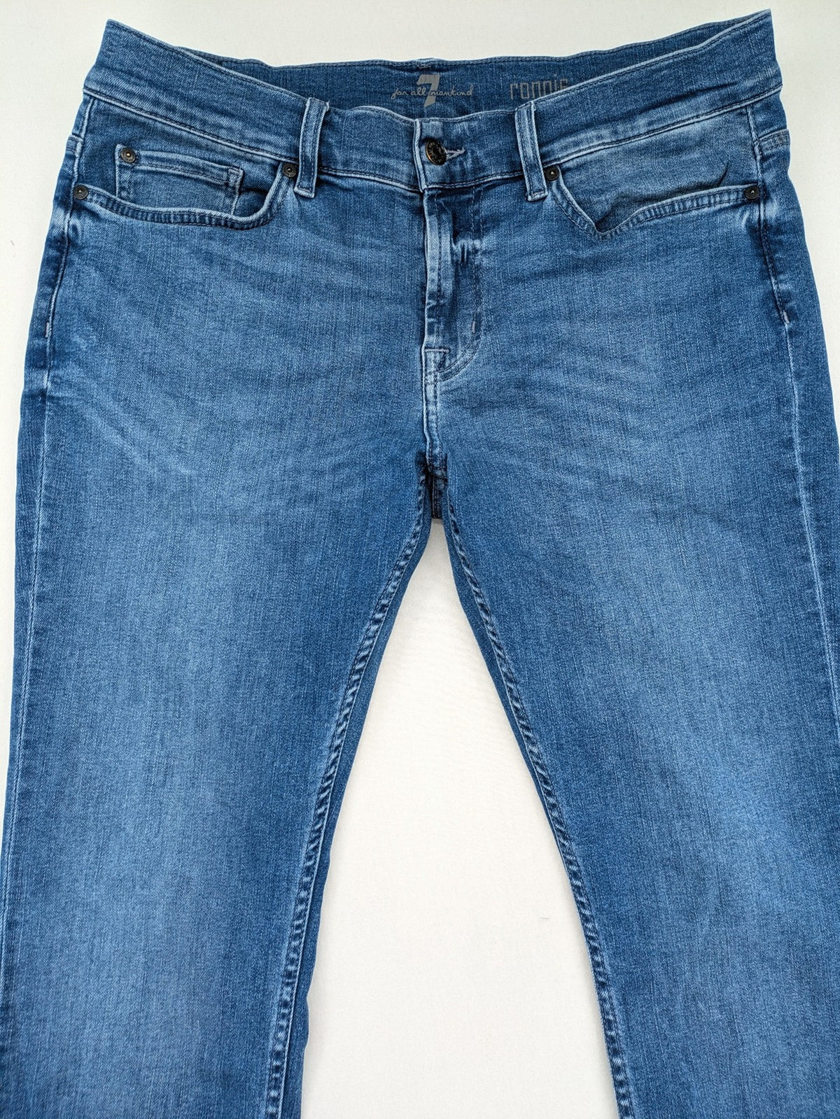 7 For All Mankind blue straight jeans with 5-pocket design and logo on back pocket.