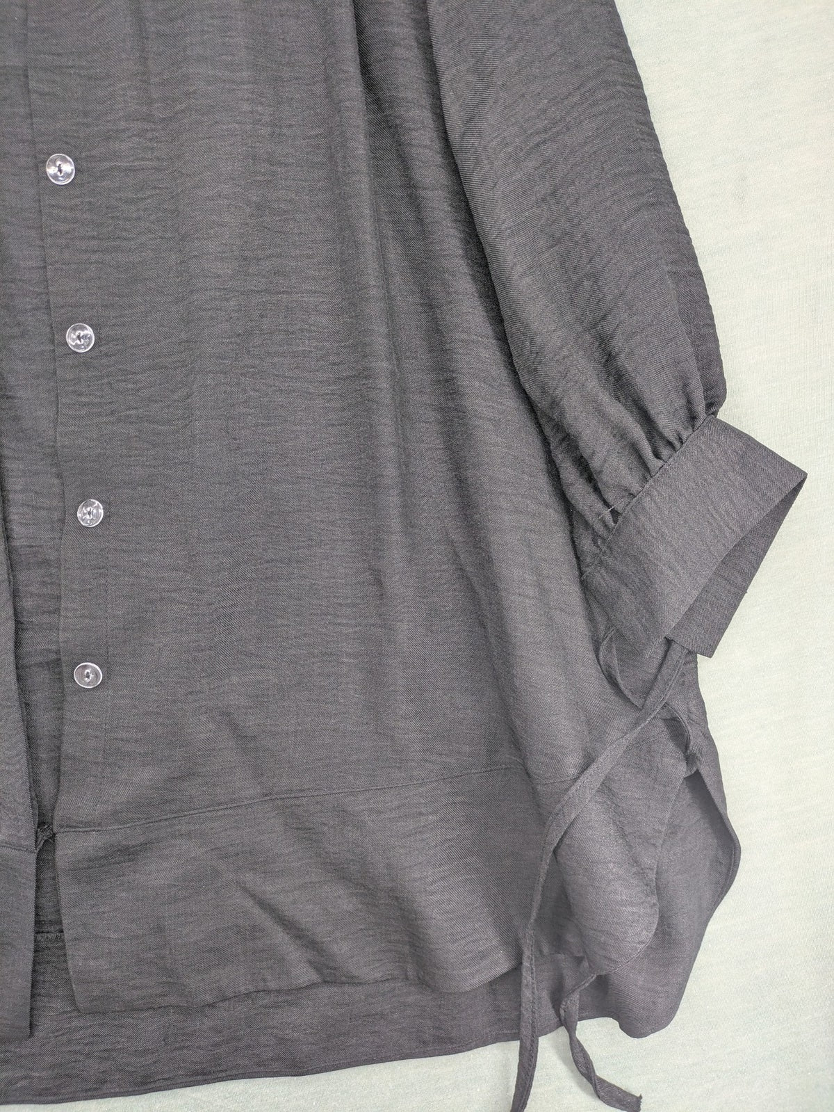 Damen grey turtle neck jumper with balloon sleeves and side ties, high-low hem.