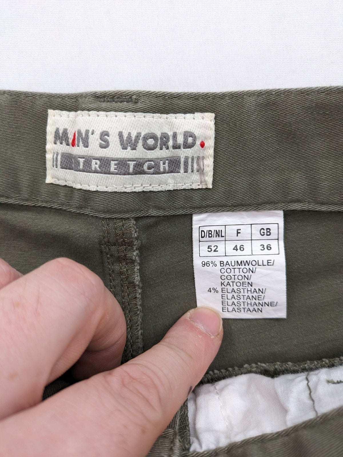 Man's World khaki chino pants with button and zipper closure, made from cotton-elastane blend.