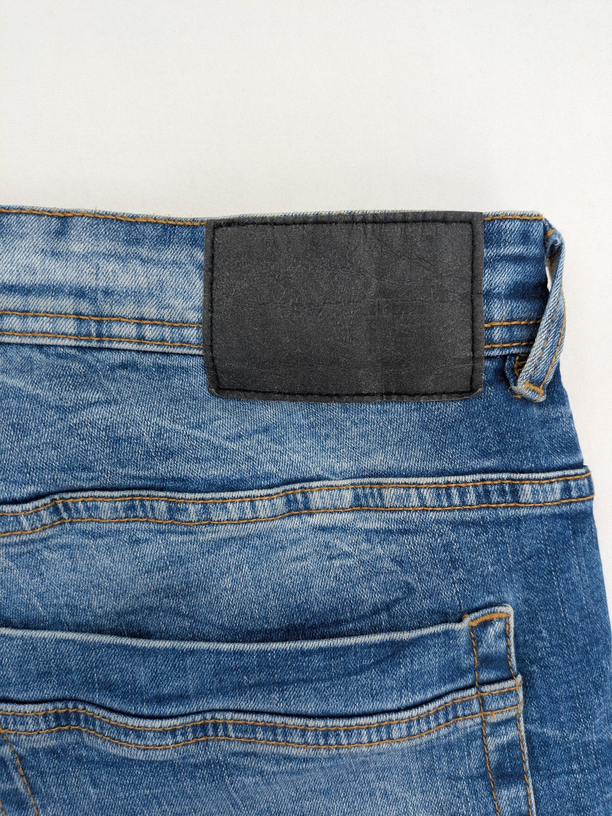 Smog blue denim shorts slim fit distressed details with rolled hem.