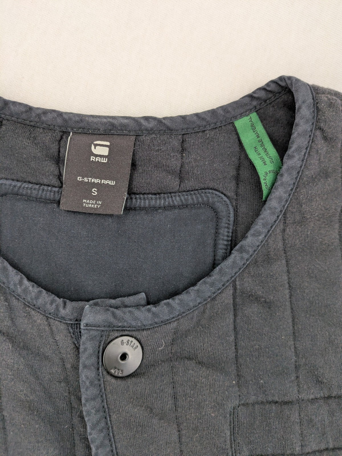 G-Star Raw grey quilted jacket with button closure and adjustable drawstring hem.