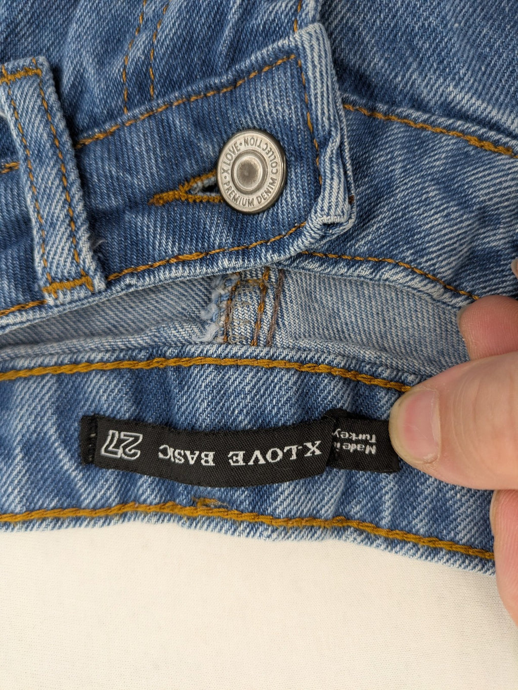 X.LOVE blue high waist wide leg jeans with front pleats and frayed hem.