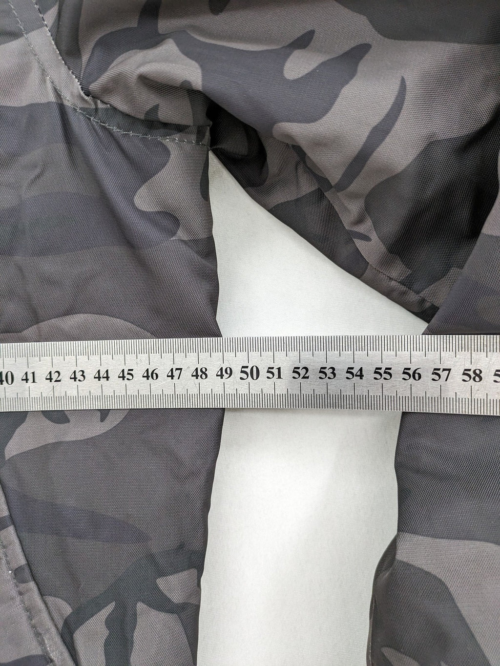 FB Sister orange bomber jacket with gray camouflage pattern and quilted lining.