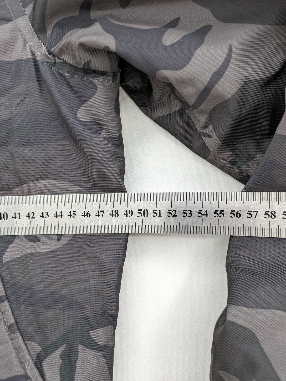FB Sister orange bomber jacket with gray camouflage pattern and quilted lining.
