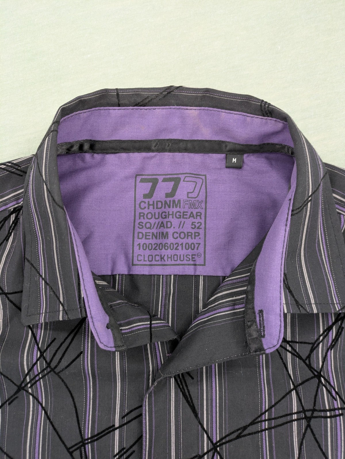 Clockhouse short-sleeve shirt grey purple striped with abstract black graphic pattern and purple collar.