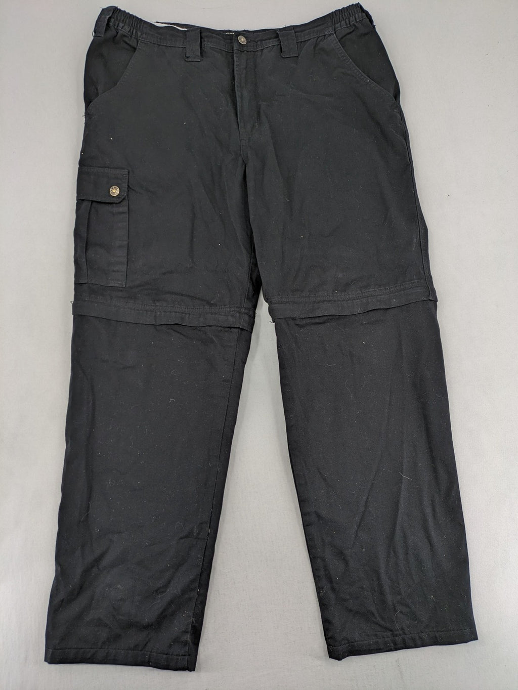 Travel Master black hunting and tactical pants, zip-off design, 100% cotton, multiple pockets.