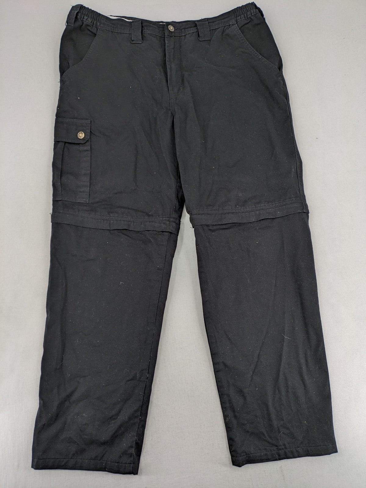 Travel Master black hunting and tactical pants, zip-off design, 100% cotton, multiple pockets.