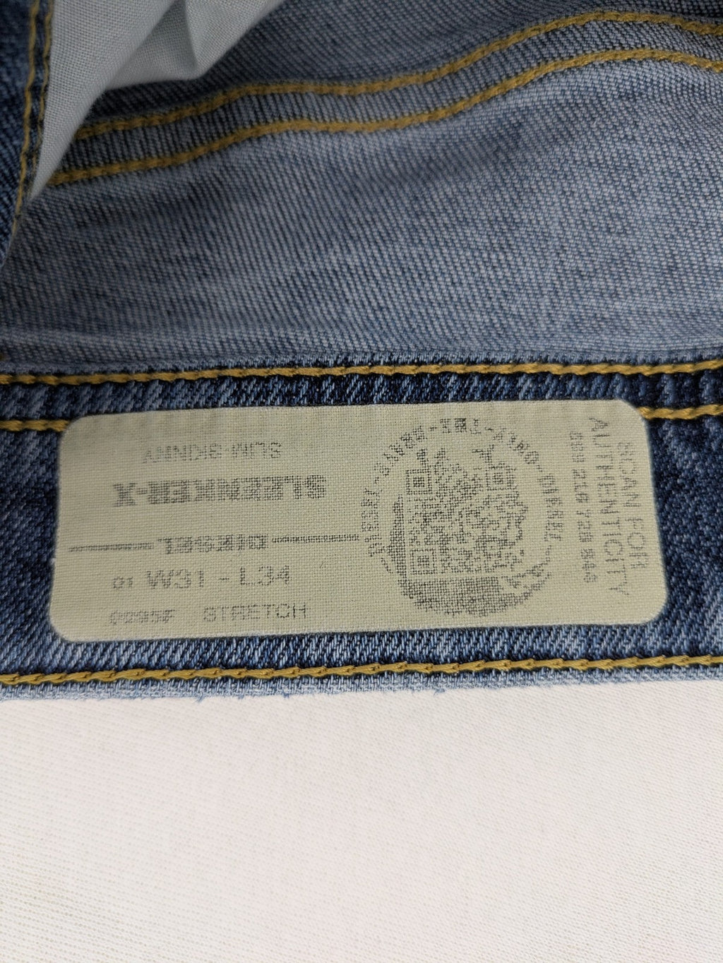 Diesel blue slim skinny jeans with logo patch and stretch denim material.