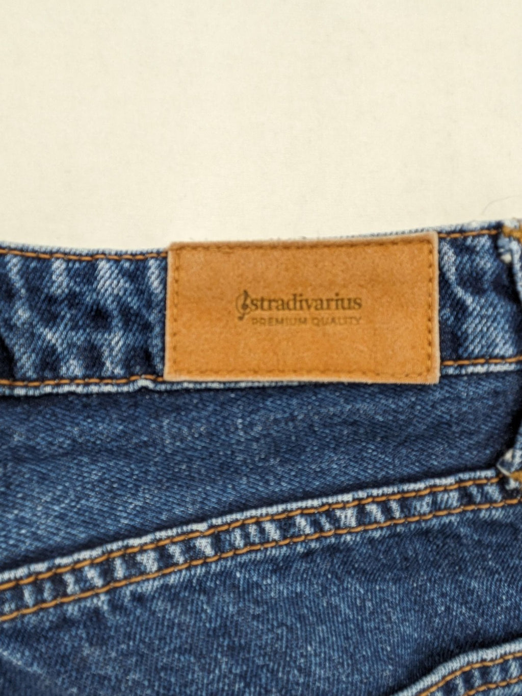 Stradivarius blue mom jeans high waist with button fly and classic denim texture.