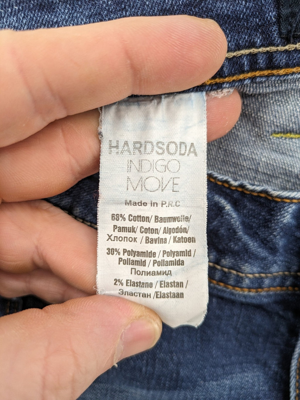 Soda blue straight jeans with distressed rips and button fly, cotton blend material.