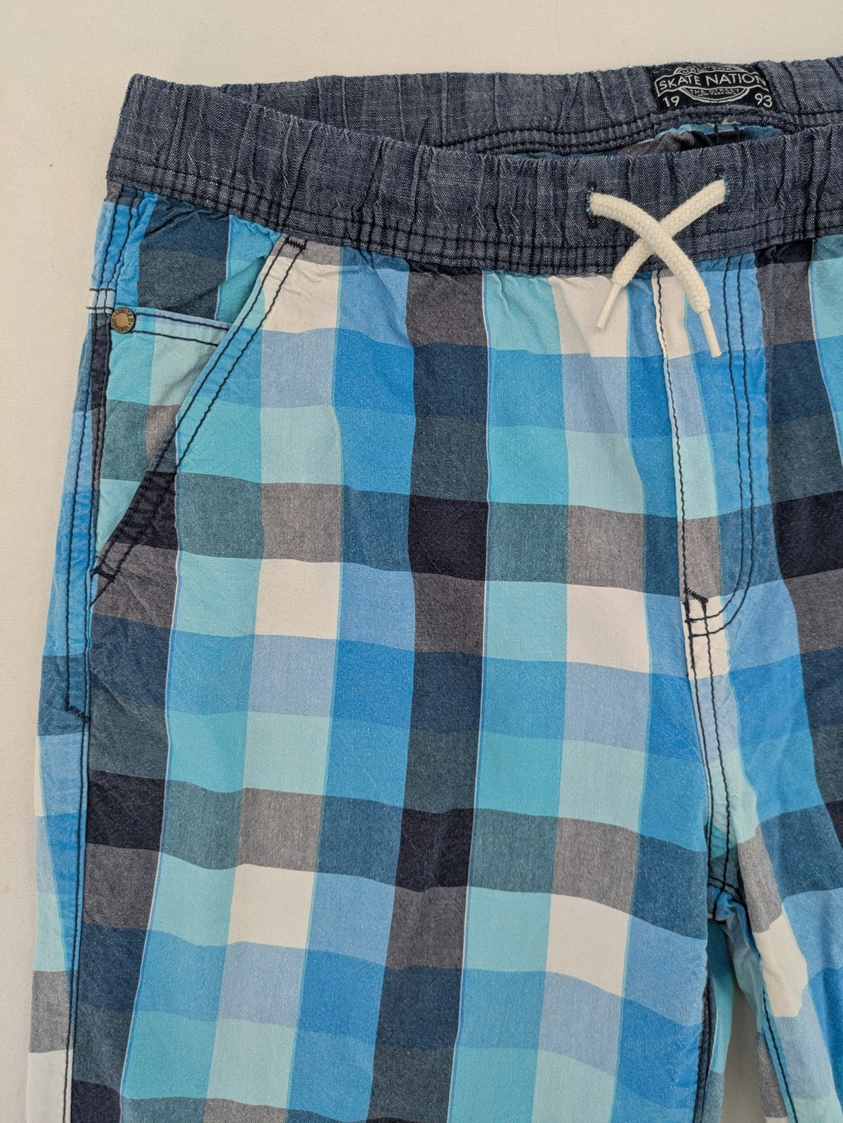 C&A blue checkered shorts with elastic waistband and side pockets, Skate Nation style.