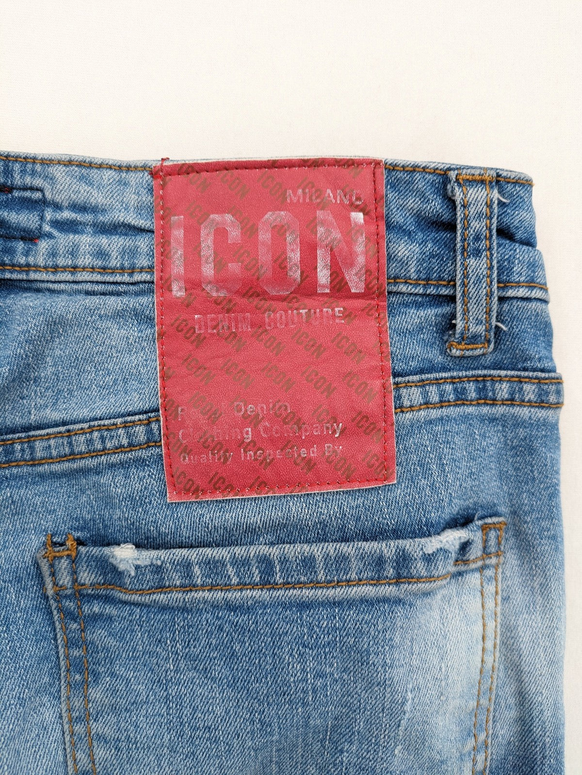 Milano straight jeans light blue distressed with red splatter and extra slim fit.