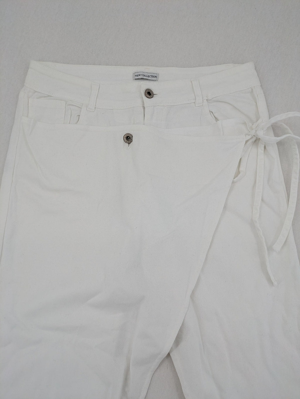New Collection white straight jeans asymmetrical wrap design with side lacing and cotton-stretch material.