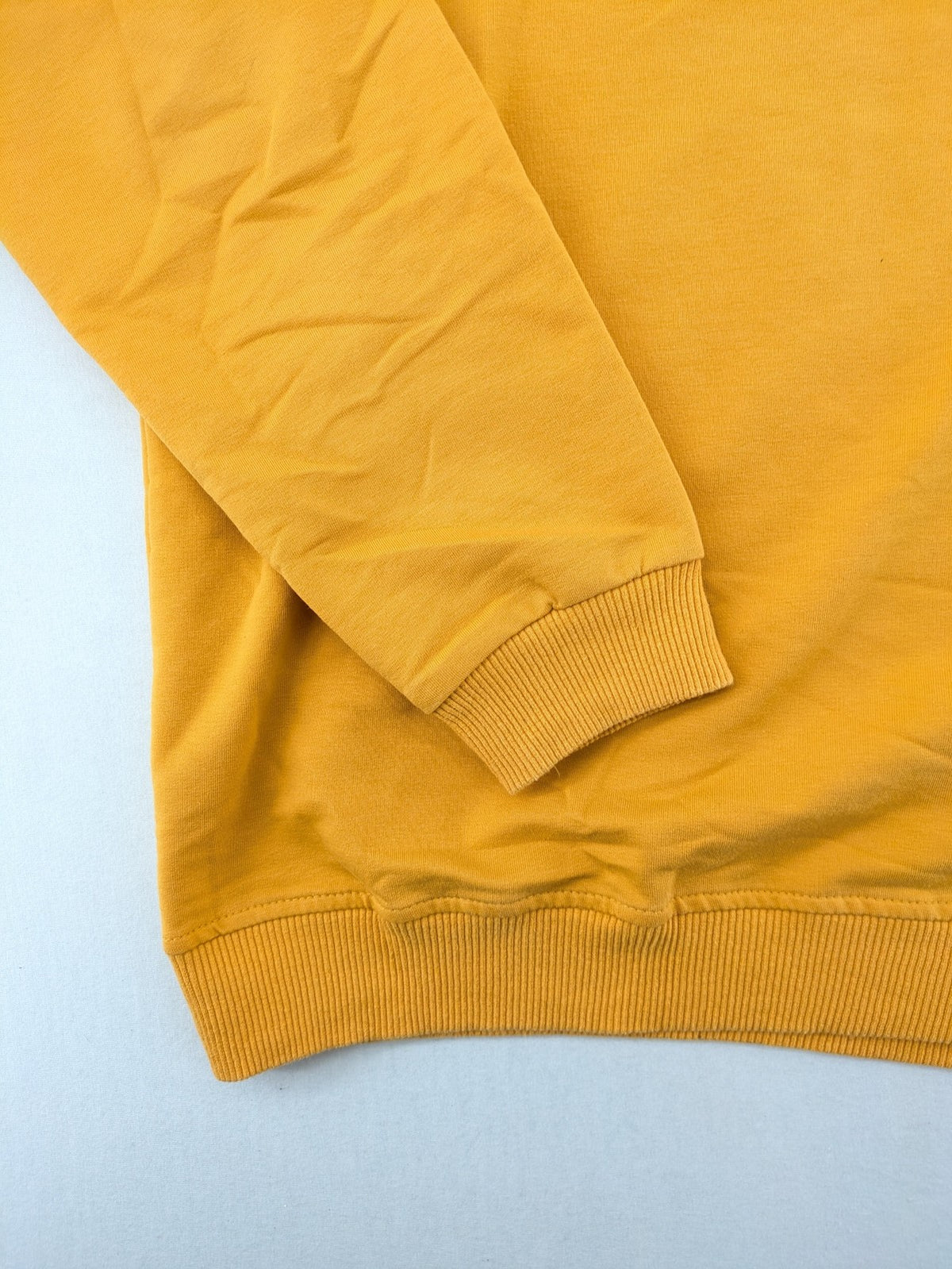 Columbia yellow turtle neck jumper with iconic logo, ribbed cuffs, and soft cotton material.