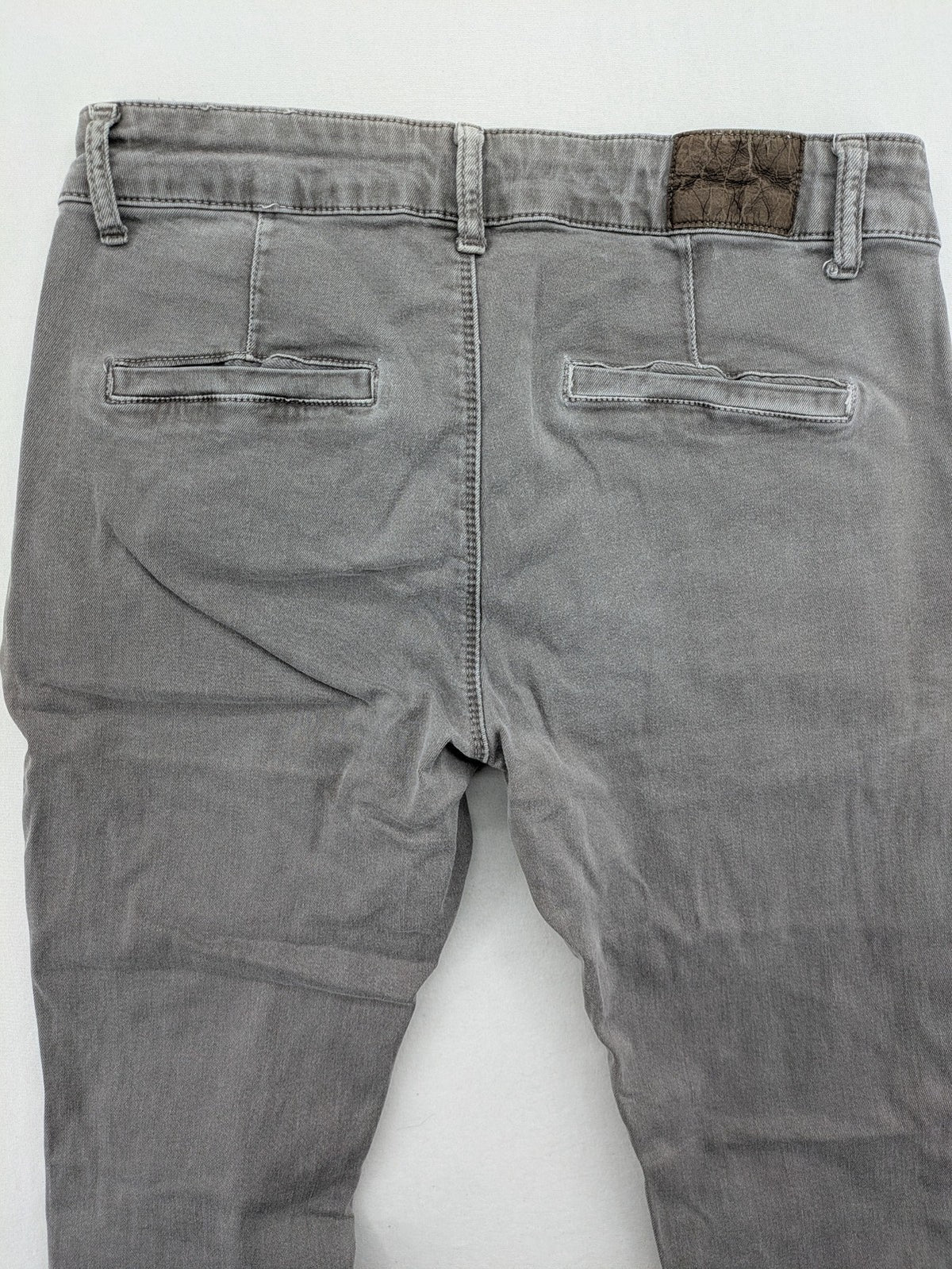 Made in Italy grey biker jeans with zip pockets and structured knee detailing.