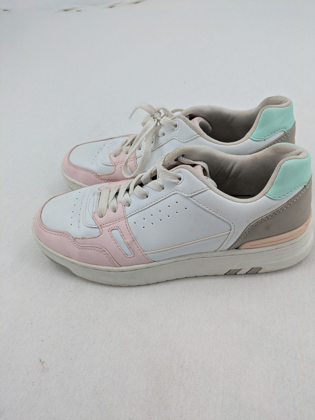 Graceland white sneakers with pink and mint green accents, low-top design, cushioned tongue.