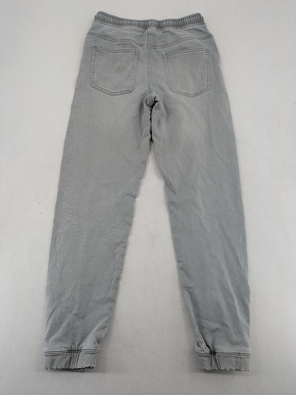 Denim & Co. grey jogger jeans with elastic waistband and ankle cuffs, cotton material.
